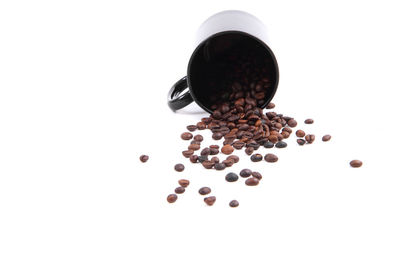 High angle view of coffee beans against white background