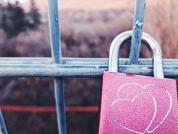 Close-up of padlocks on railing