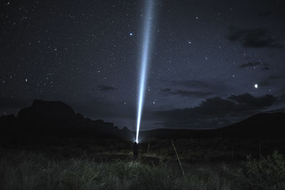 Scenic view of mountains against sky at night