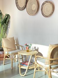 Empty chairs and table against wall at home