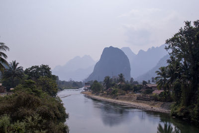 Scenic view of river and mountains against sky