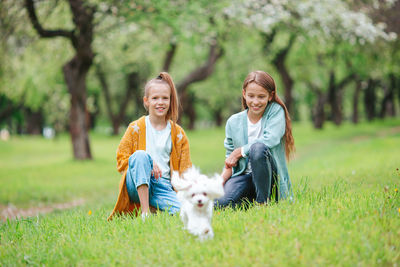 Woman with dog on plant against trees and plants