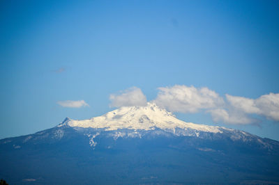 Scenic view of mountains against cloudy sky