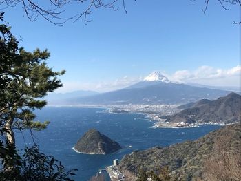 Scenic view of sea and mountains against sky