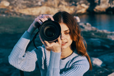 Portrait of woman photographing