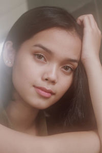 Close-up portrait of a smiling young woman