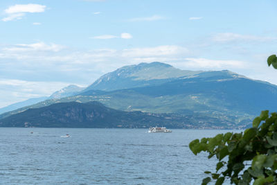 Scenic view of sea and mountains against sky