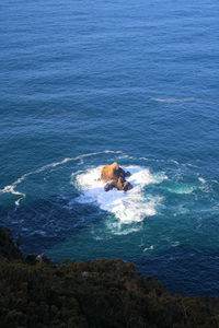 Rocks in the middle of the sea, waves crashing on the rocks