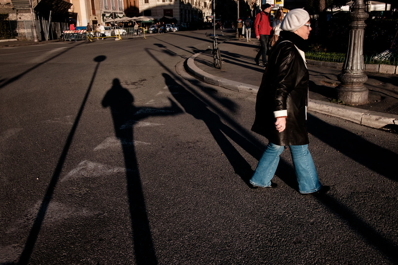 shadow, sunlight, real people, men, outdoors, day, leisure activity, lifestyles, road, full length, one person, city, adult, people