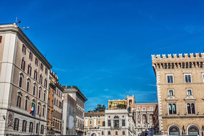 Low angle view of buildings against blue sky