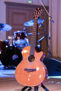 Close-up of acoustic guitar on scene 