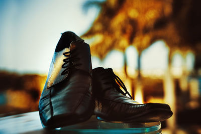 Close-up of shoes on table against sky