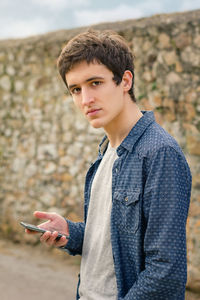 Portrait of young man using mobile phone
