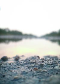 Close-up of water on beach against clear sky