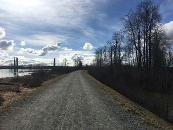 Road amidst trees against sky