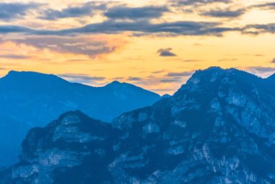 Scenic view of snowcapped mountains against sky during sunset