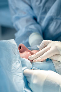 Midsection of doctor examining patient in hospital