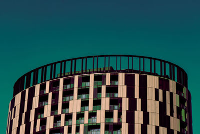 Low angle view of modern building against clear blue sky