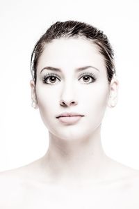 Close-up portrait of a beautiful young woman over white background