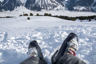 Low section of person on snow covered mountain