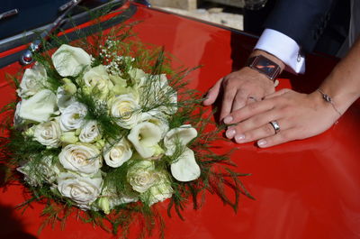 Midsection of woman holding rose bouquet