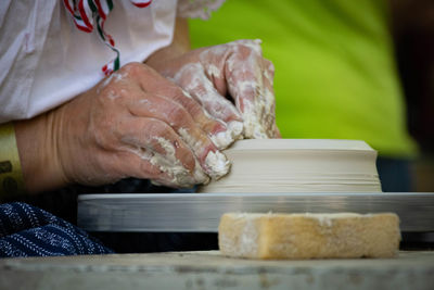 Close-up of man working on pottery wheel