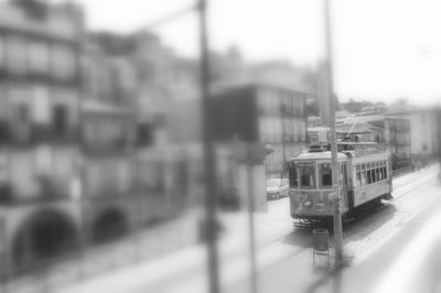 Blurred motion of train on street in city