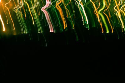 Low angle view of illuminated colorful lights
