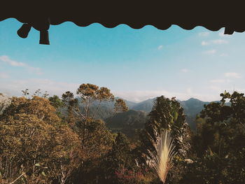 Scenic view of mountains against cloudy sky