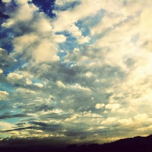 Scenic view of mountains against cloudy sky