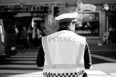 Rear view of police man on city street