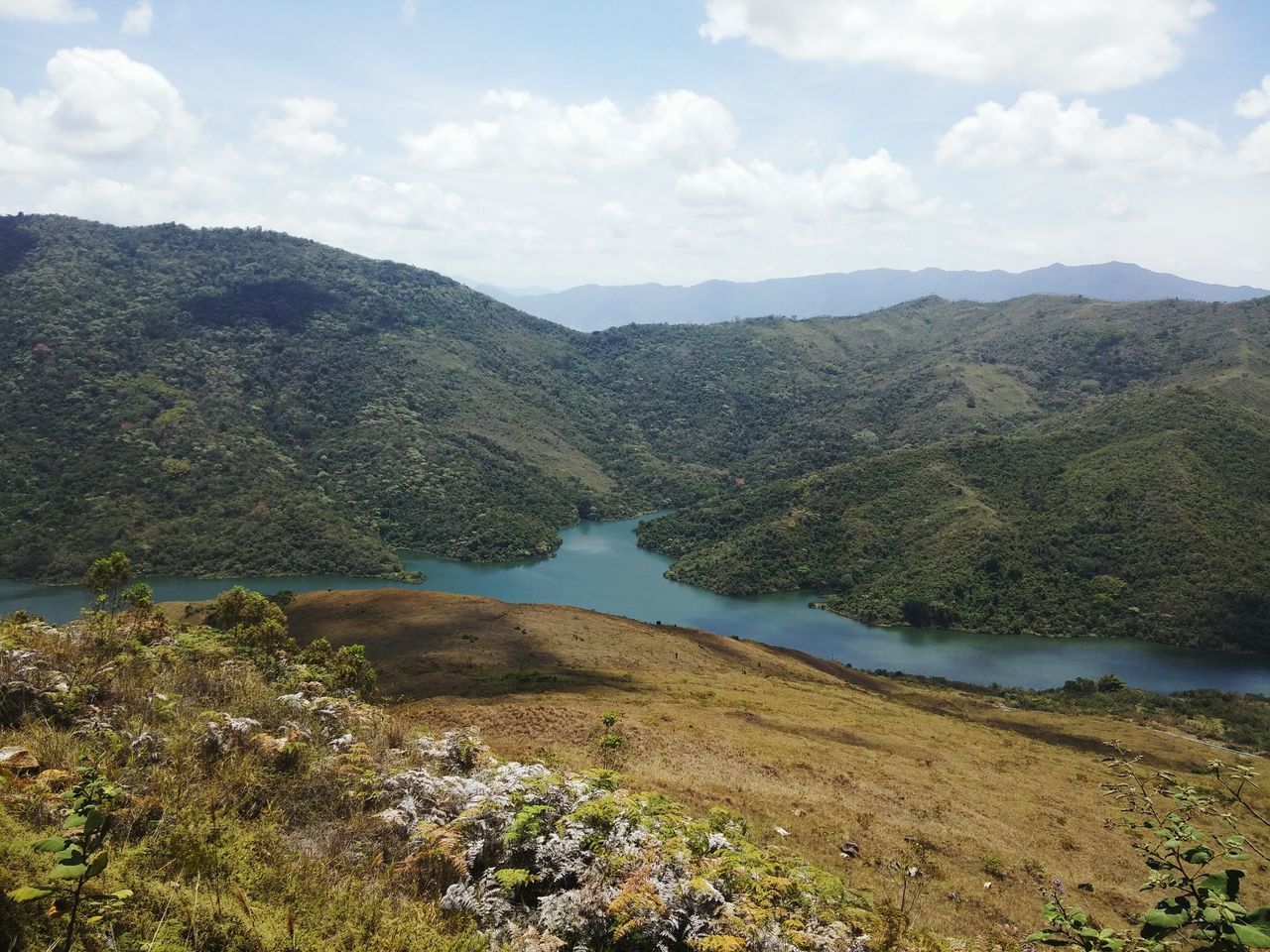 mountain, tranquil scene, tranquility, scenics, sky, water, mountain range, beauty in nature, landscape, nature, lake, cloud - sky, cloud, non-urban scene, idyllic, river, day, plant, high angle view, remote