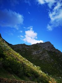 Low angle view of mountain against blue sky