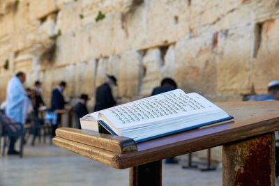 Close-up of book on table against wall