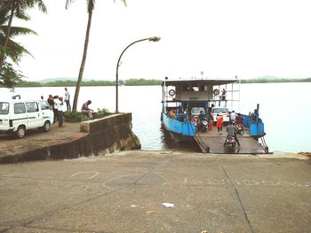 People on boat against sky
