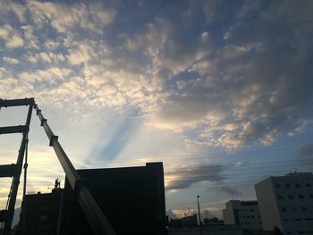 Low angle view of city against sky during sunset