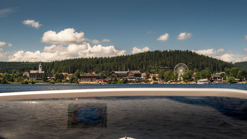 View of swimming pool in lake against cloudy sky