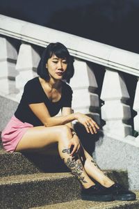Portrait of woman sitting on steps