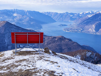 Big red bench on the landscape of lake como