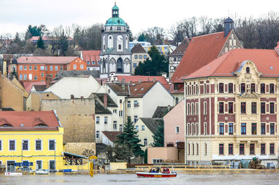 Buildings in city against clear sky