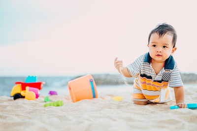 Boy playing with toy on beach