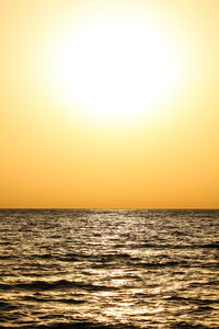 Scenic view of sea against orange sky