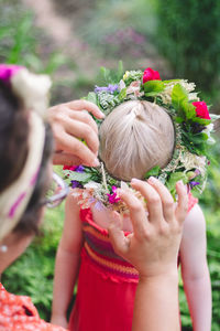 Low angle view of girl holding flowering plant