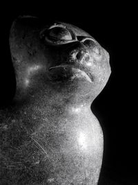 Close-up of statue against black background