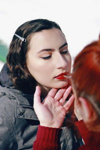 Artist doing make-up of woman