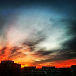 Low angle view of buildings against sky at sunset