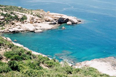 High angle view of rock formations by sea