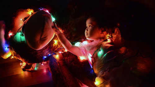 Close-up of girl holding toy with illuminated lights at home