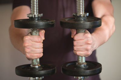 Close-up of hand holding dumbbells