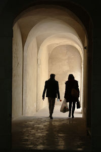 Silhouette people walking in corridor